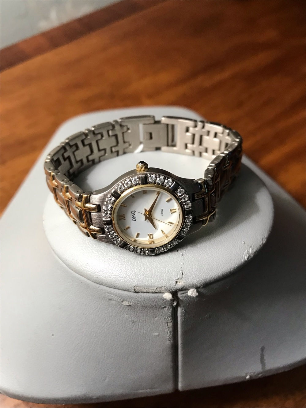 DMQ Two-Tone Swiss quartz bracelet watch with crystal accents.